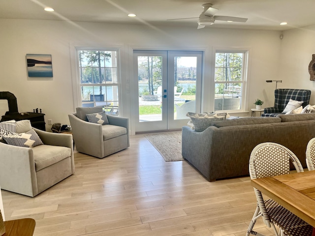 living area with french doors, a ceiling fan, light wood-style floors, and recessed lighting