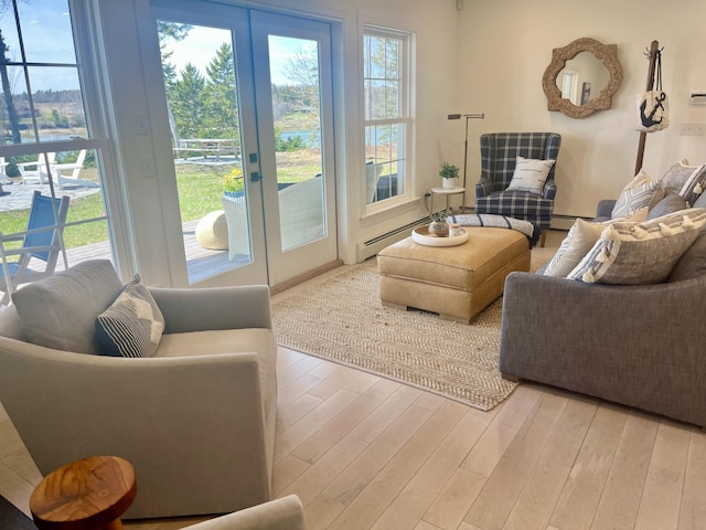 living area with light wood-style floors, french doors, and a wealth of natural light