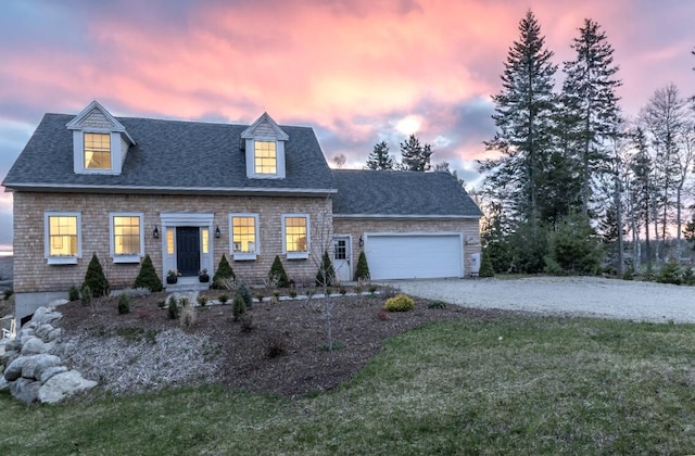 view of front facade featuring a garage, driveway, a front yard, and a shingled roof