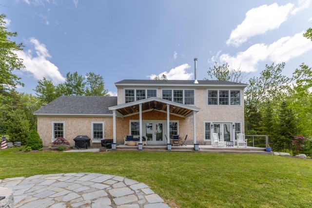 52 Boulder Cove Way, Lamoine, ME 04605 - rear view of property featuring french doors, a patio area, a lawn, and roof with shingles