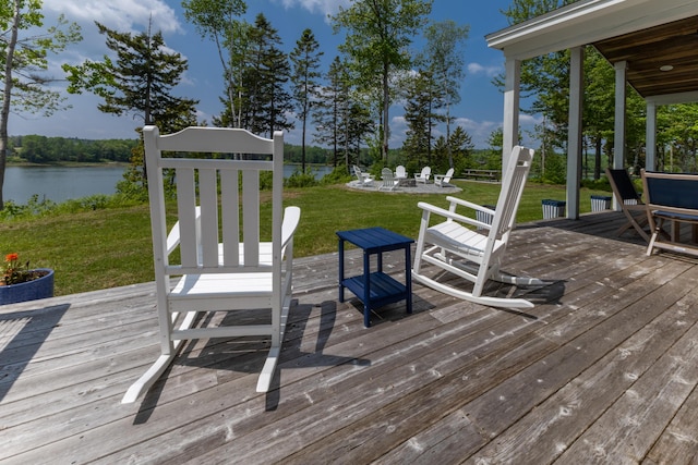 52 Boulder Cove Way, Lamoine, ME 04605 - wooden deck with a water view, a fire pit, and a yard
