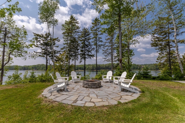 52 Boulder Cove Way, Lamoine, ME 04605 - view of grassy yard with an outdoor fire pit, a water view, and a patio area