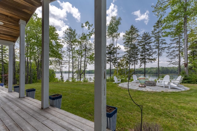52 Boulder Cove Way, Lamoine, ME 04605 - wooden terrace featuring a water view, a fire pit, and a lawn