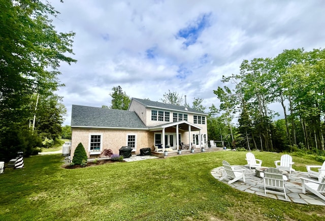 52 Boulder Cove Way, Lamoine, ME 04605 - back of house with a patio, an outdoor fire pit, a lawn, and a shingled roof