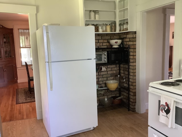 kitchen with wood finished floors and white appliances