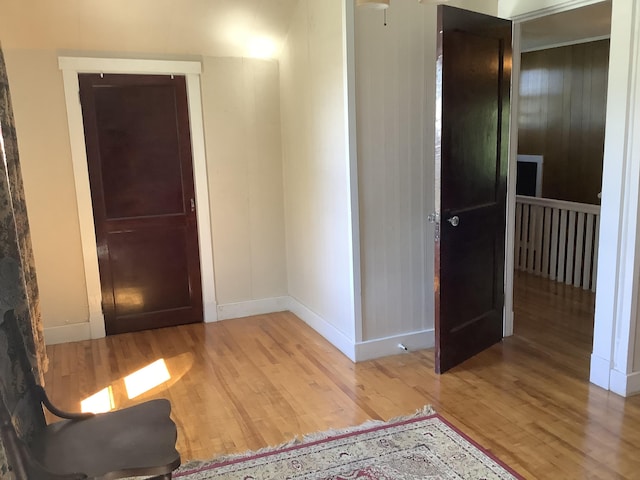 interior space featuring baseboards and wood finished floors