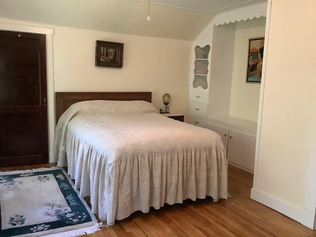 bedroom featuring baseboards and wood finished floors