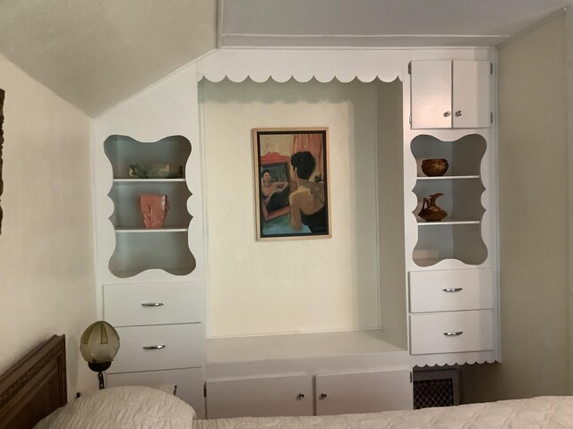 bedroom featuring lofted ceiling and visible vents