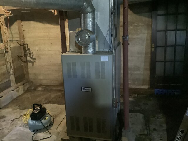 utility room with heating unit