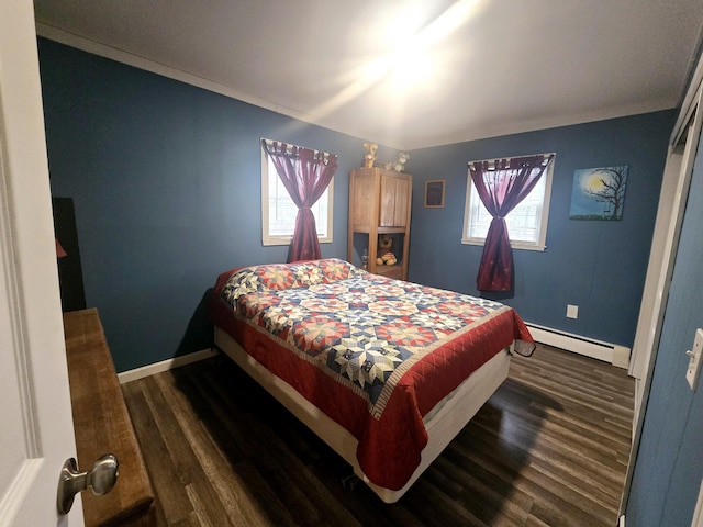 bedroom featuring a baseboard heating unit, baseboards, and dark wood-style floors