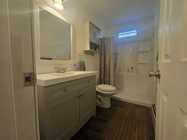 bathroom with toilet, vanity, wood finished floors, and curtained shower