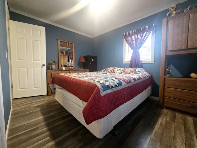 bedroom featuring ornamental molding and dark wood-style floors