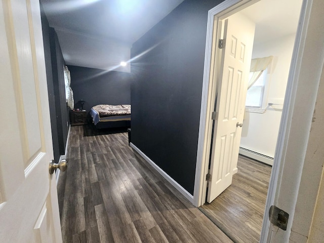 corridor with a baseboard radiator and wood finished floors