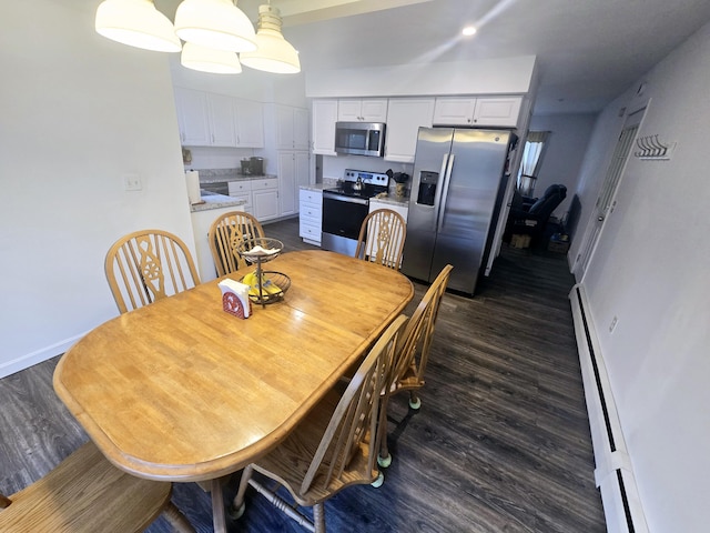 dining space with baseboard heating, baseboards, dark wood-style floors, and recessed lighting