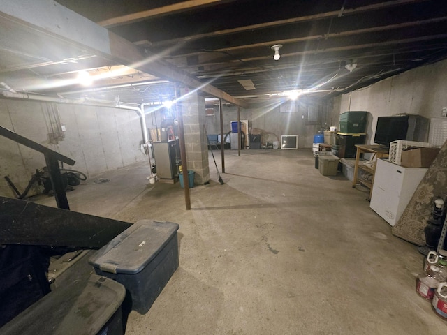unfinished basement featuring heating unit