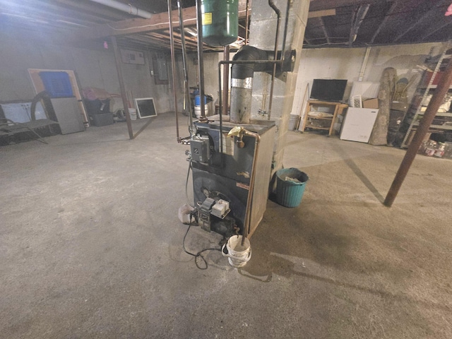 unfinished basement featuring a heating unit