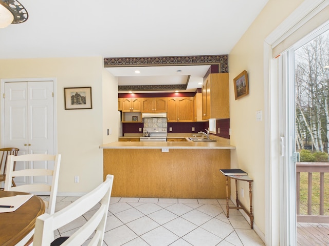 274 19th Ave, Madawaska, ME 04756 - kitchen featuring white electric range oven, a sink, light countertops, backsplash, and under cabinet range hood