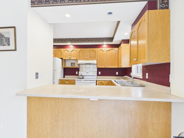 274 19th Ave, Madawaska, ME 04756 - kitchen with white appliances, light countertops, backsplash, a peninsula, and under cabinet range hood