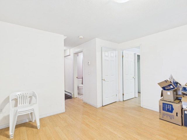 274 19th Ave, Madawaska, ME 04756 - unfurnished room with a baseboard heating unit, light wood finished floors, and baseboards