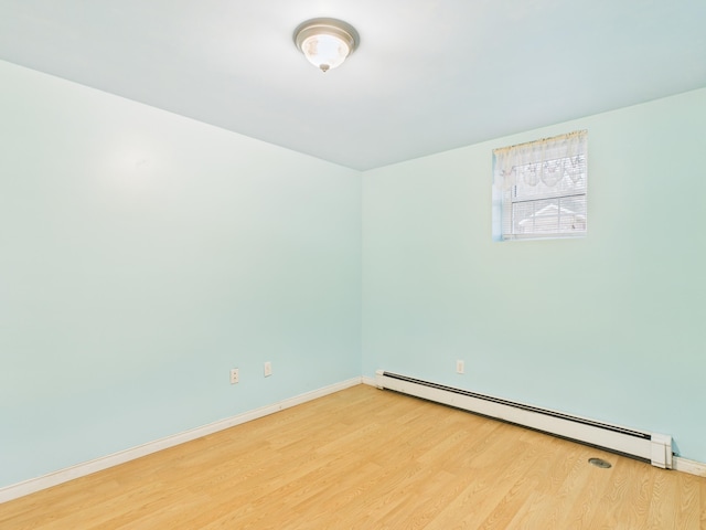 274 19th Ave, Madawaska, ME 04756 - spare room with a baseboard heating unit, light wood-type flooring, and baseboards