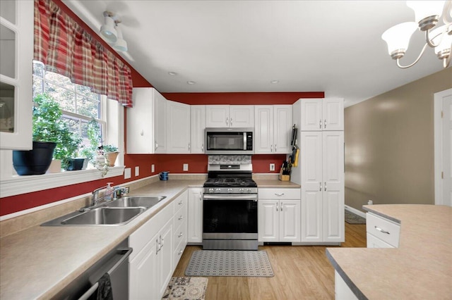 95 The Woods Rd, Union, ME 04862 - kitchen with appliances with stainless steel finishes, light wood-style flooring, light countertops, and white cabinets