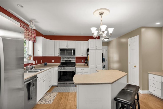 95 The Woods Rd, Union, ME 04862 - kitchen featuring appliances with stainless steel finishes, light wood-style flooring, white cabinets, light countertops, and recessed lighting