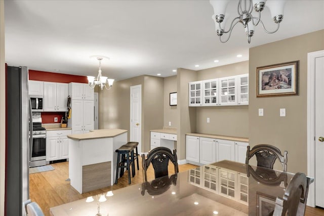 95 The Woods Rd, Union, ME 04862 - kitchen featuring a chandelier, stainless steel appliances, white cabinets, light wood-style flooring, and recessed lighting