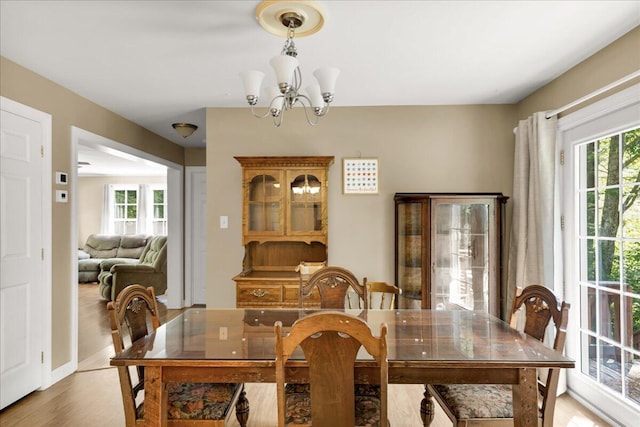 95 The Woods Rd, Union, ME 04862 - dining area featuring healthy amount of natural light, light wood-style flooring, and a chandelier