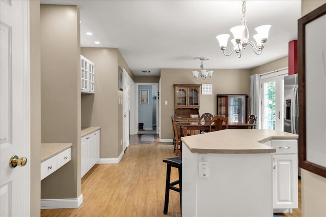 95 The Woods Rd, Union, ME 04862 - kitchen with a chandelier, light countertops, white cabinetry, light wood-type flooring, and recessed lighting