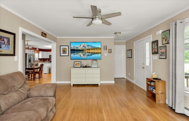 95 The Woods Rd, Union, ME 04862 - living area with light wood-style floors, a ceiling fan, ornamental molding, and a baseboard radiator