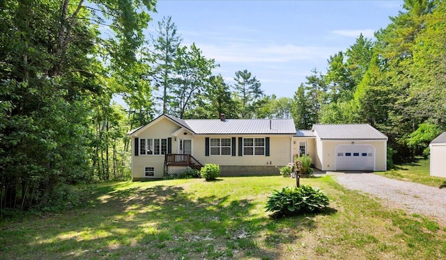 95 The Woods Rd, Union, ME 04862 - single story home with a garage, driveway, a front lawn, and a metal roof