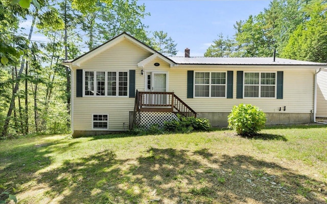 95 The Woods Rd, Union, ME 04862 - view of front of house featuring a chimney, a front lawn, and a metal roof