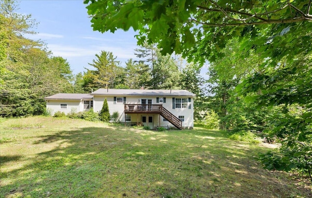 95 The Woods Rd, Union, ME 04862 - rear view of house with a deck, stairs, and a yard