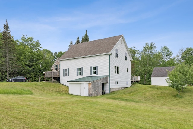 1228 Long Plains Rd, Buxton, ME 04093 - back of property with a lawn, a wooden deck, a storage unit, and roof with shingles