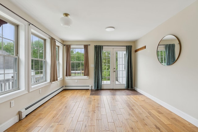1228 Long Plains Rd, Buxton, ME 04093 - empty room featuring light wood-style flooring, french doors, and baseboard heating