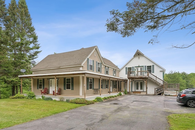 1228 Long Plains Rd, Buxton, ME 04093 - view of front of property with french doors, a porch, a front yard, asphalt driveway, and a shingled roof