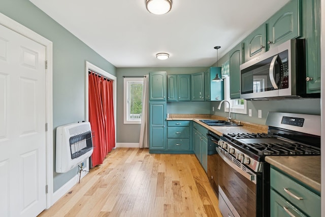 1228 Long Plains Rd, Buxton, ME 04093 - kitchen with stainless steel appliances, green cabinets, heating unit, light wood finished floors, and pendant lighting