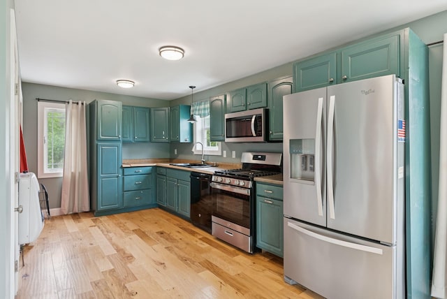 1228 Long Plains Rd, Buxton, ME 04093 - kitchen featuring stainless steel appliances, plenty of natural light, light wood-type flooring, and pendant lighting