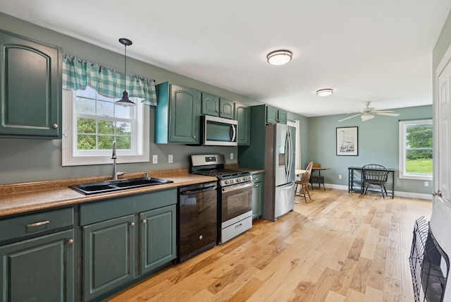 1228 Long Plains Rd, Buxton, ME 04093 - kitchen with stainless steel appliances, green cabinetry, light wood finished floors, decorative light fixtures, and a ceiling fan