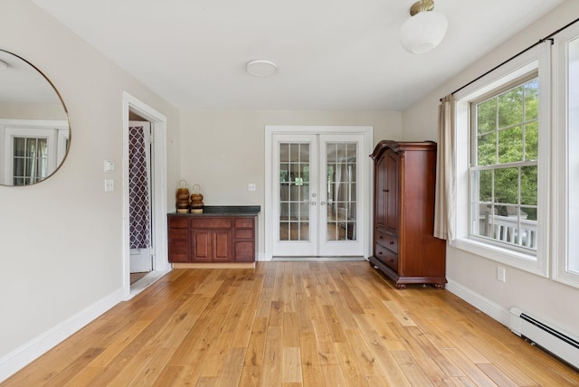 1228 Long Plains Rd, Buxton, ME 04093 - unfurnished living room with a baseboard radiator, french doors, and light wood-type flooring