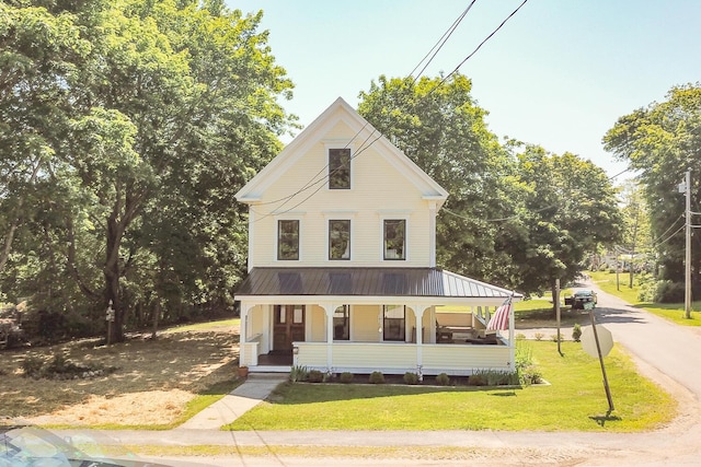 34 Harbor Rd, Friendship, ME 04547 - view of front facade featuring a front lawn, metal roof, and covered porch