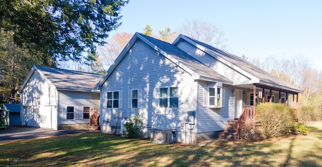 view of home's exterior with a lawn, central AC unit, stairs, and a porch