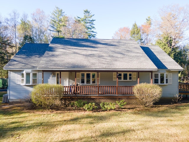 single story home featuring covered porch, roof with shingles, and a front lawn