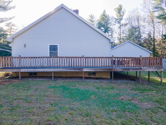 exterior space with a wooden deck, a yard, and a chimney