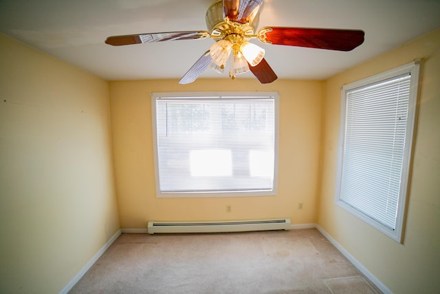 spare room with carpet floors, a ceiling fan, baseboards, and baseboard heating