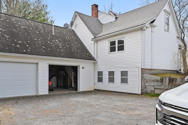 107 Northern Ave, Augusta, ME 04330 - view of side of property featuring a shingled roof, a chimney, driveway, and a garage