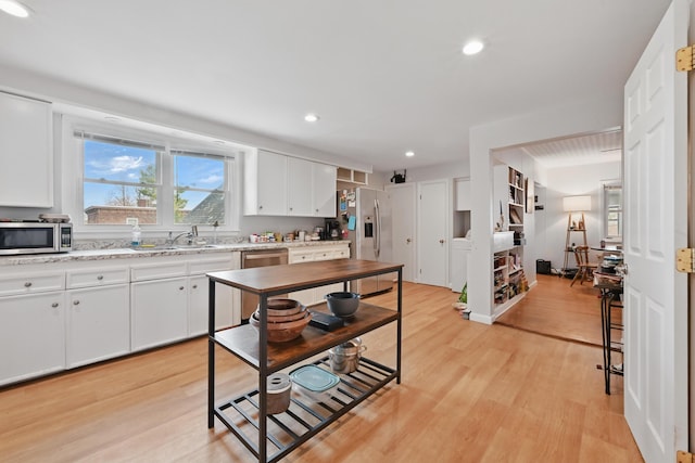 107 Northern Ave, Augusta, ME 04330 - kitchen featuring appliances with stainless steel finishes, a sink, light wood finished floors, white cabinetry, and recessed lighting