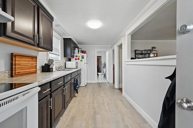 107 Northern Ave, Augusta, ME 04330 - kitchen featuring wall chimney range hood, dark brown cabinetry, light wood-style floors, and light countertops