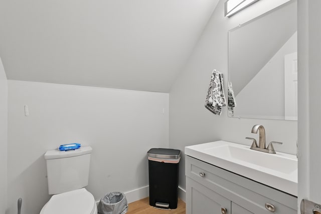 107 Northern Ave, Augusta, ME 04330 - bathroom with vanity, toilet, wood finished floors, and lofted ceiling