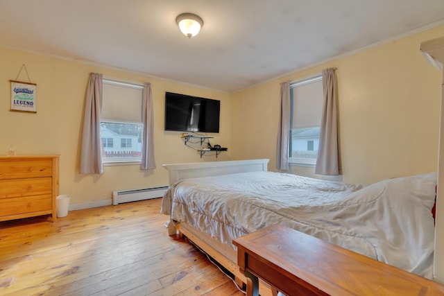 99 Ocean Park Rd, Saco, ME 04072 - bedroom featuring a baseboard radiator, ornamental molding, and wood-type flooring